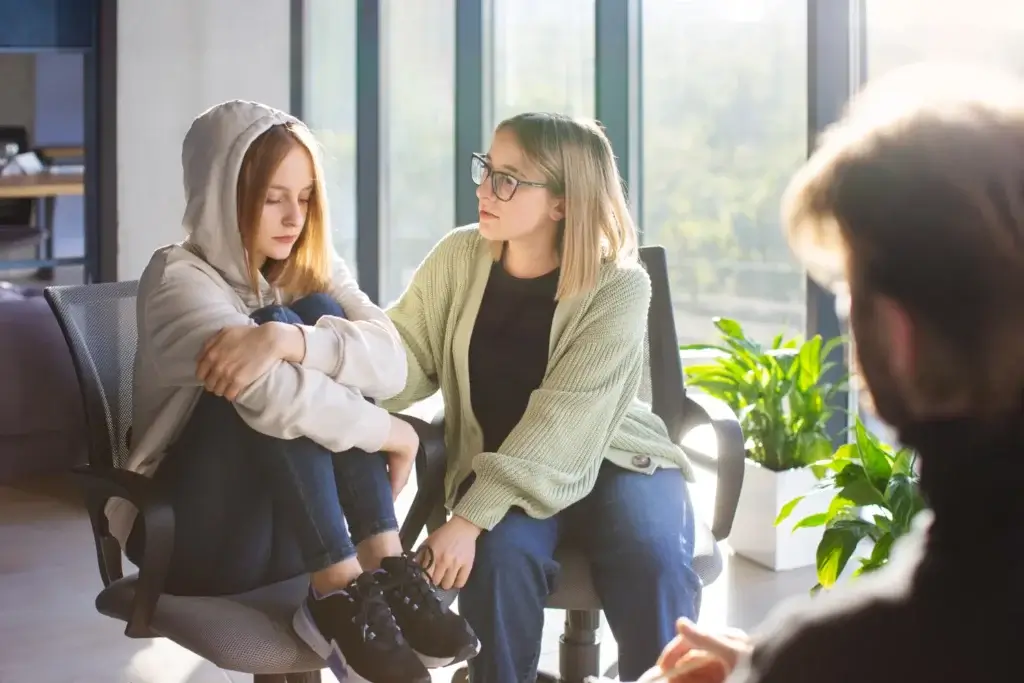 Two women in conversation during a therapy session about navigating life transitions.
